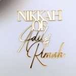 Personalised acrylic nikkah name cake charm in gold.